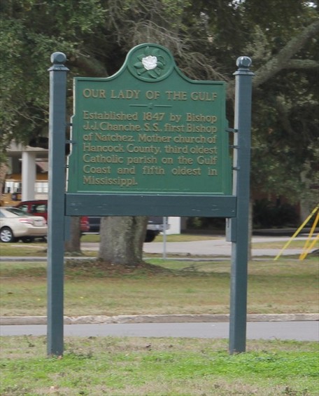 The historical marker is located next to the sidewalk in front of the church. The parish is the third oldest on the Gulf Coast.