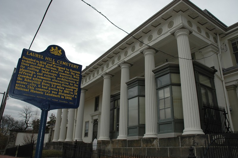 Laurel Hill's famous gatehouse, designed by John Notman, sits behind its historical marker.