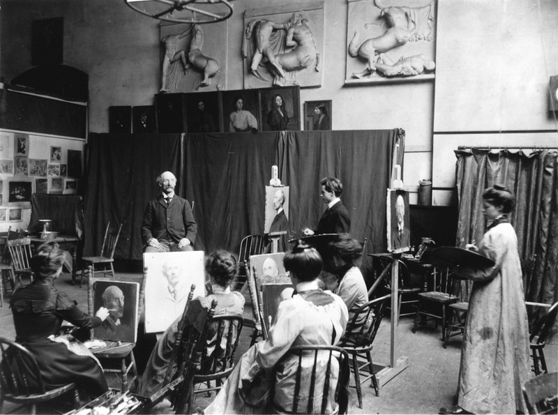 An elderly gentleman poses for students of the academy in this early 20th century photograph.