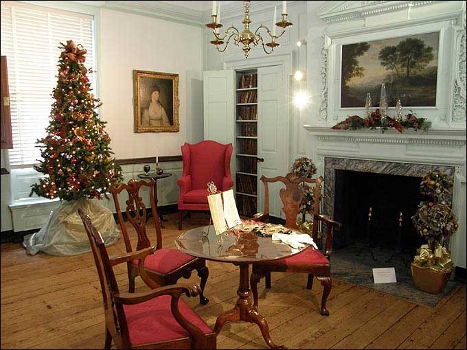 The parlor at Woodford boasts antique furniture and a beautiful fireplace overmantel.