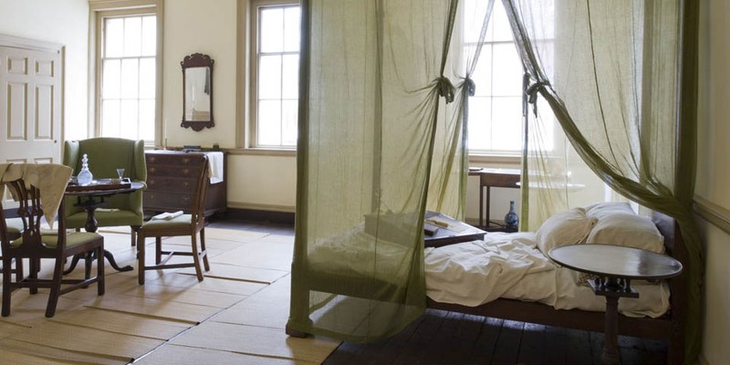 The Bishop's bedroom with the last book read by Dr. White still on his lap desk. Notice the mosquito netting, a lasting reminder of the yellow fever epidemics that ravaged the city during his lifetime.