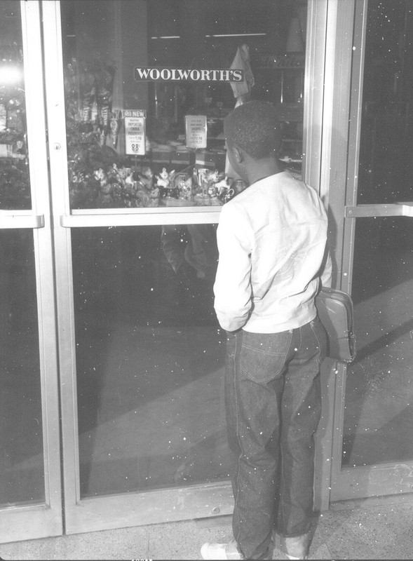 man standing outside woolworth