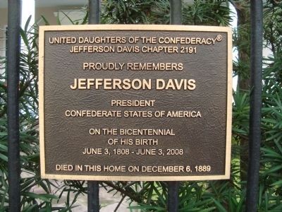 The historical marker on the fence outside of the home.