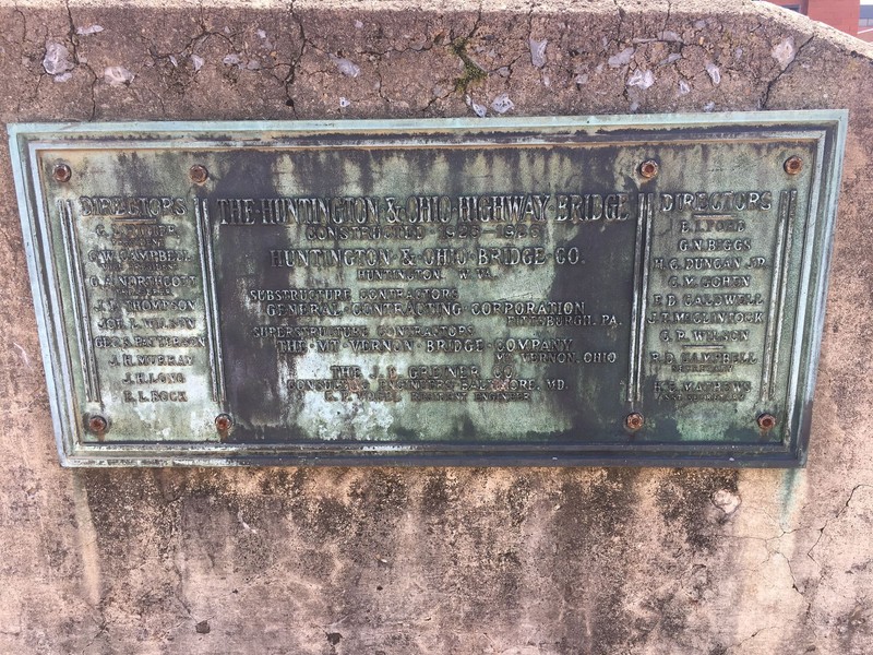 A surviving slab of concrete with the original bridge's dedication plaque is on display at Huntington's Heritage Station. Image courtesy of Steven Cody Straley.