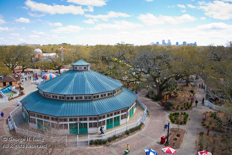This aerial shot of the carousel was taken from the park's Ferris wheel.  The city's skyline can be seen in the distance.  