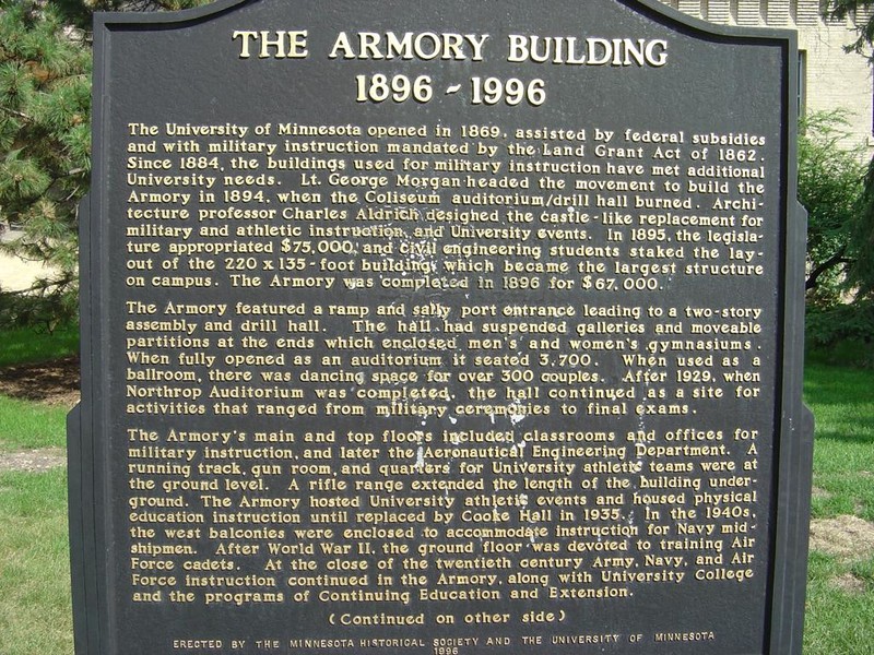 The front side of the plaque outside the Armory, detailing its first hundred years 