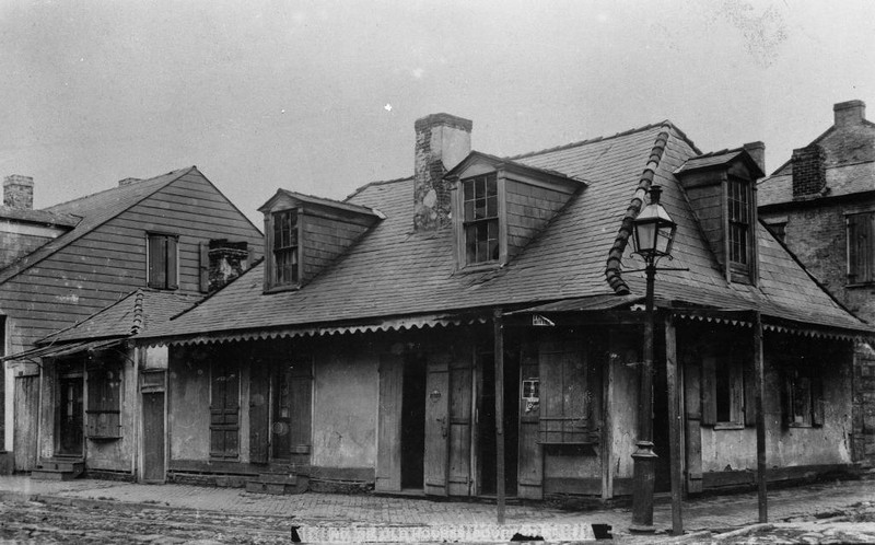 This c. 1900 photograph of Lafitte's shows the small outbuilding, on the left, that once existed where the courtyard was later built.  