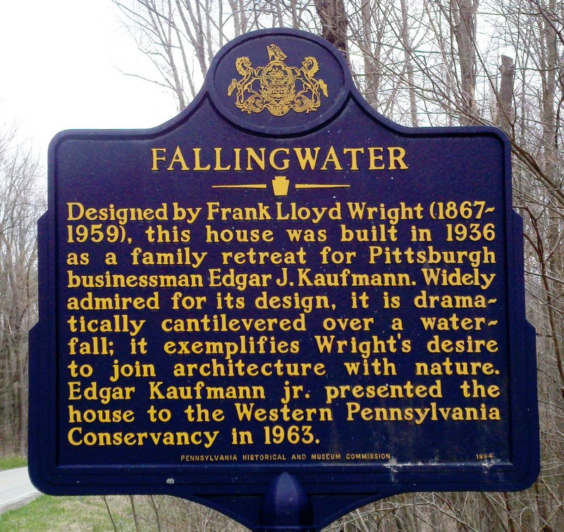 This colorful photo shows the blue Historical Landmark sign that sits just slightly down the road, on the side opposite from Fallingwater.