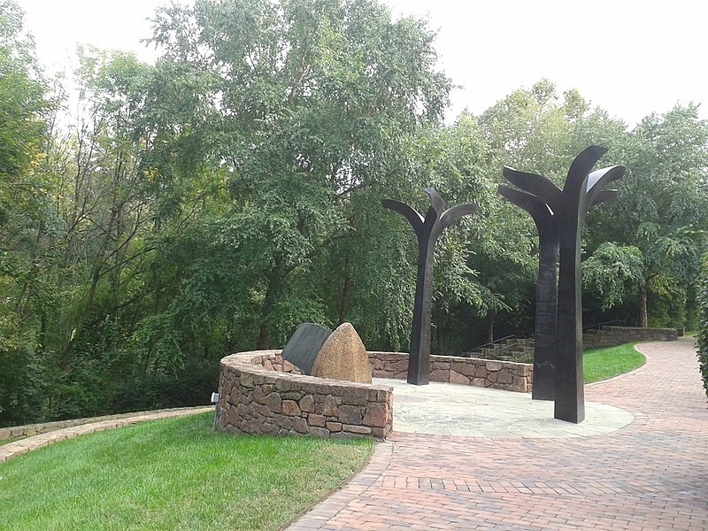 The sculpture group "Truths That Rise From the Roots Remembered" was created by artist Jerome Meadows.