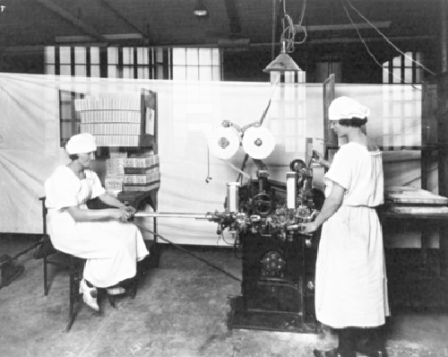 Circa 1915. These women are operating the factory's gum-wrapping machine