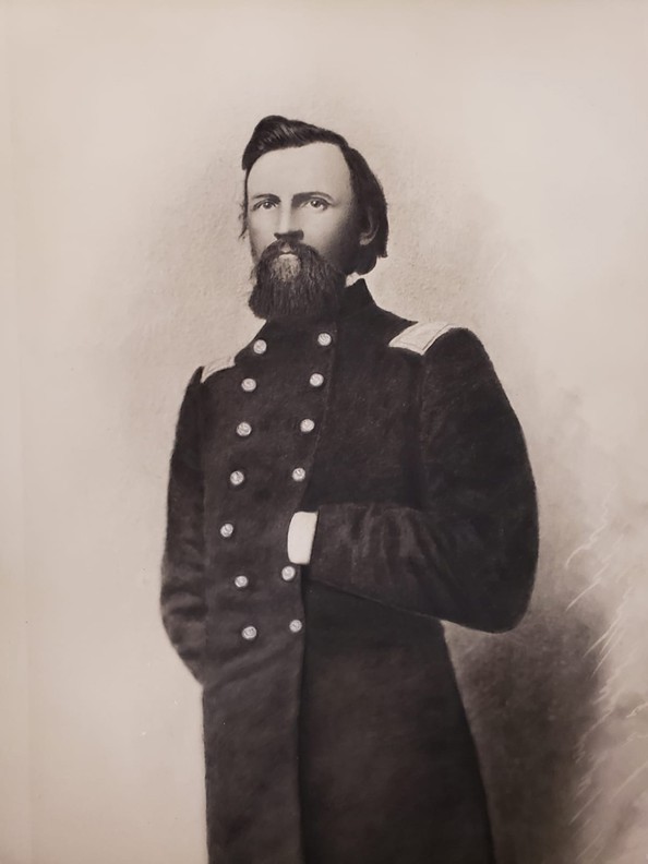 Large charcoal portrait of Hans C. Heg, the colonel of the 15th Wisconsin Infantry Regiment during the Civil War and a prominent state politician prior to the war. The portrait shows a bearded Heg in full Union uniform with his right hand behind his back and his left hand in the front of his coat.  