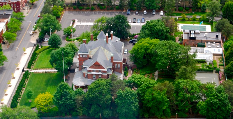 This aerial shot reveals how large the mansion and compound have become, to include an outdoor pool and tennis court.  