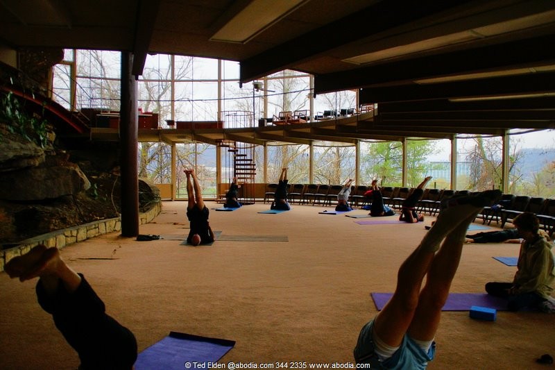 A yoga class provides a sense of scale to one of the circular rooms.