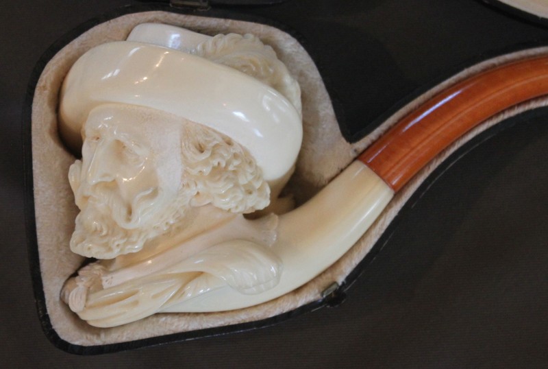 The mineral sepiolite, makes the two meerschaum pipes depicting the likenesses of Peter Paul Ruben and Sire Anthony Van Dyke. Meerschaum can be both carved and polished and the pipes are usually created underwater to maintain the minerals pliability. During the Victorian era, these status symbols were often carved images from history, literature and art but soon gave way to the new look of Art Deco after WWI.