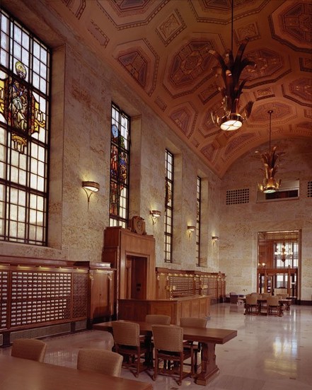 The library's Great Hall/foyer features a 42-foot vaulted ceiling, stained glass windows and its original reference desk.