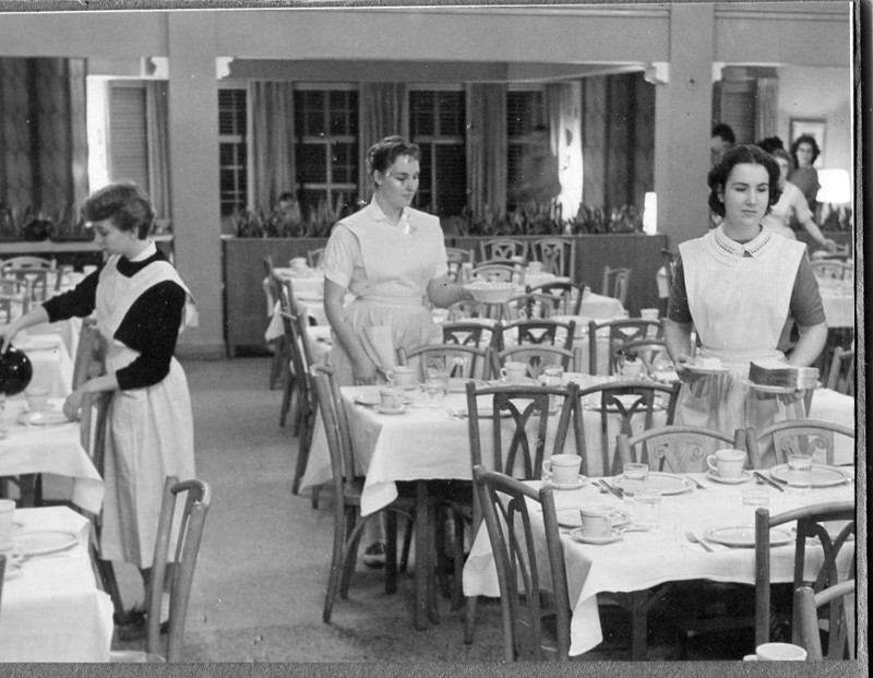 Students setting the tables before a meal