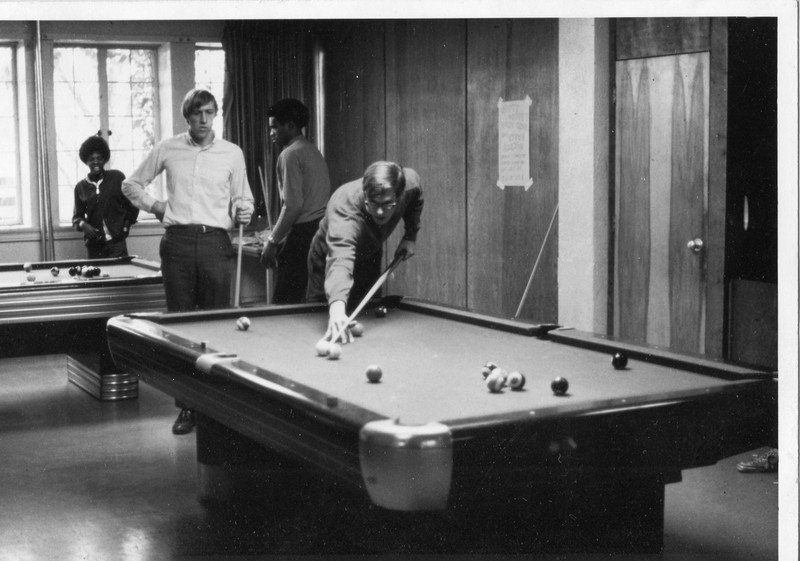 Students playing pool in the common area of Thompson
