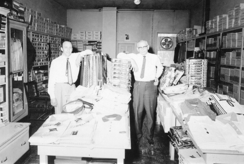 Community Shop men's store at 107 Main Street. Ernie Scholberg, left, and "Chick" Hawley (owner), right.