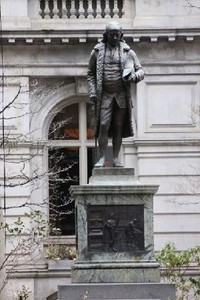 Statue of Benjamin Franklin, who attended the school before dropping out to do his studies independently. 