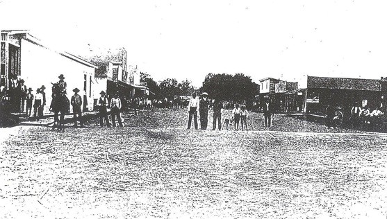 A black and white photo of a group of people standing 