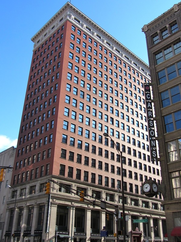 The former Merchants National Bank Building was designed to represent a Corinthian column with the base and crown separate from the red brick shaft.