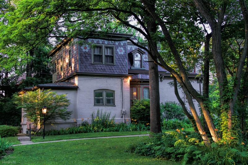 A side few of the Benton House with day lilies blooming in the foreground.  