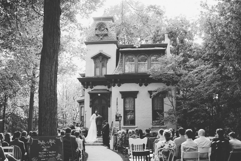 A couple is married on the steps of the Benton House.