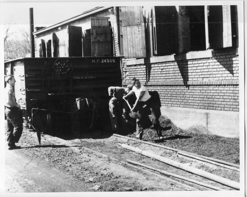 Students moving coal from the train to coal chute.