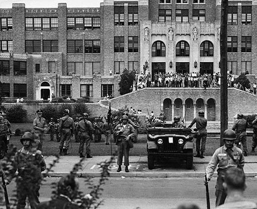 Soldiers stand guard to enforce the law at Little Rock High School, September 26, 1957