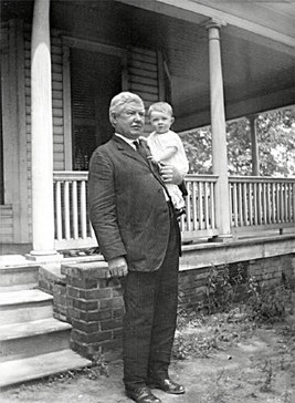 Neal Somers Alexander, pictured with a grandchild, in front of his home's sweeping porch.