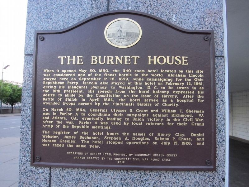 The marker is located on the corner of the building on Vine Street. 