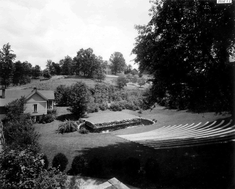 Amphitheater and Wood Cottage. The wood cottage is no longer standing on campus.