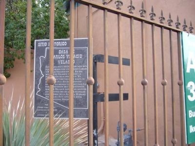 The historical marker, without the English sign, inside the metal gate.
(Bill Kirchner, The Historical Marker Database)
