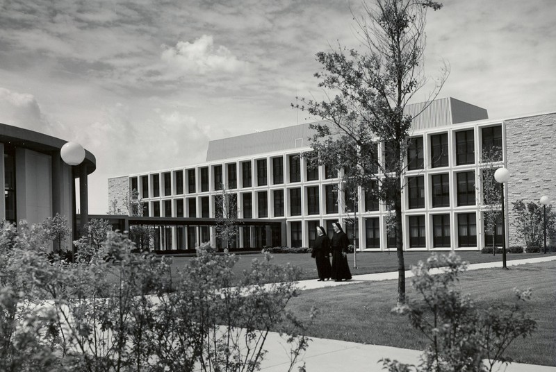 Two sisters walking through the Marian College campus, 1960s.