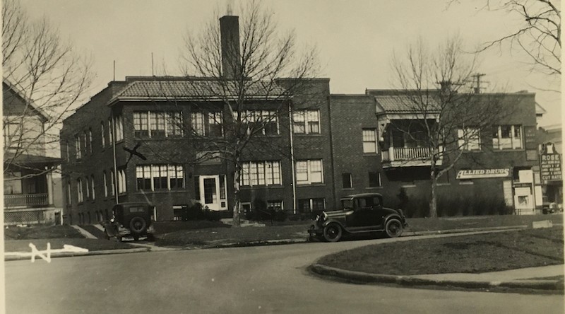 1935 Photograph of the West Boulevard Apartment Building. This is one of two NON-residential buildings with the West Boulevard Allotment. This building has two front facades-- an entrance to the apartments on West Boulevard and a storefront on Madison Avenue. When this photograph was taken, the storefront was occupied by longtime tenant, Rose Drug Store.