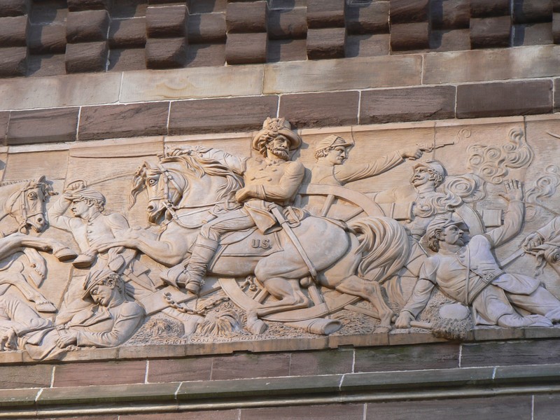 Frieze of General Ulysses S. Grant looking on has the infantry and cavalry advance on the battlefield.  