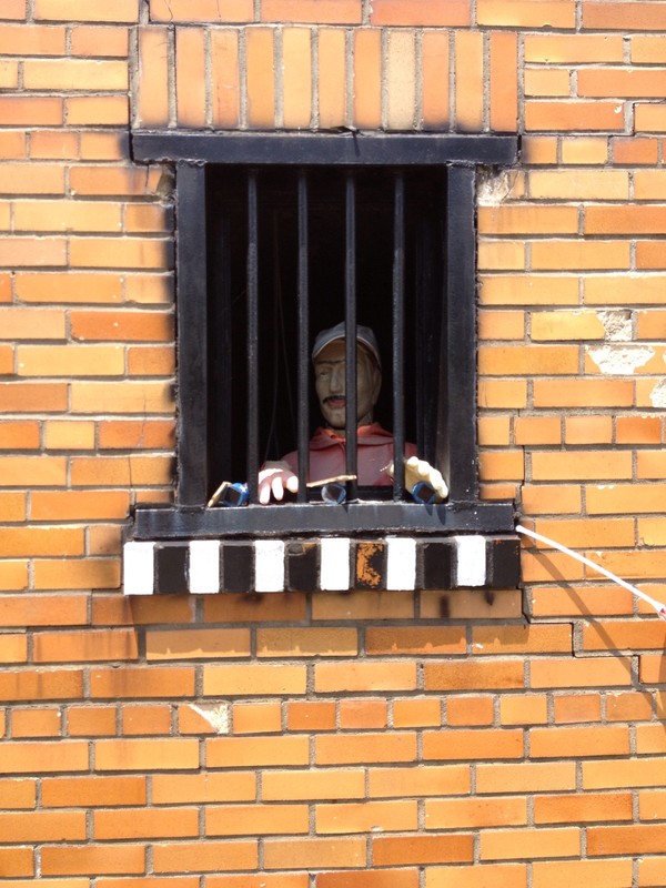 The jail features a mannequin in each of the windows