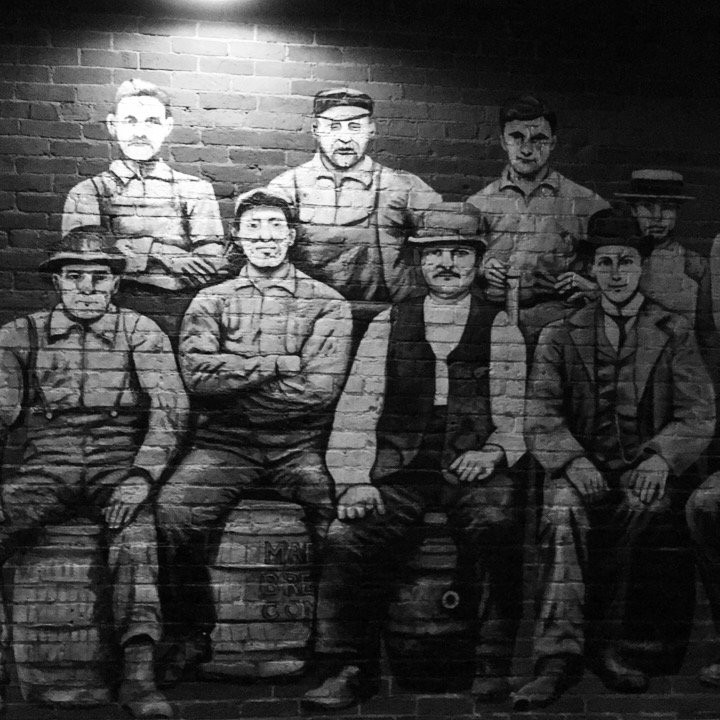 In the mural, Albert Kuehn is on a barrel second from the right in the front row. His sons Albert, George, and John Kuehn are also pictured. They worked at the brewery for a few years and later started the Kuehn Brothers tire and auto parts store.