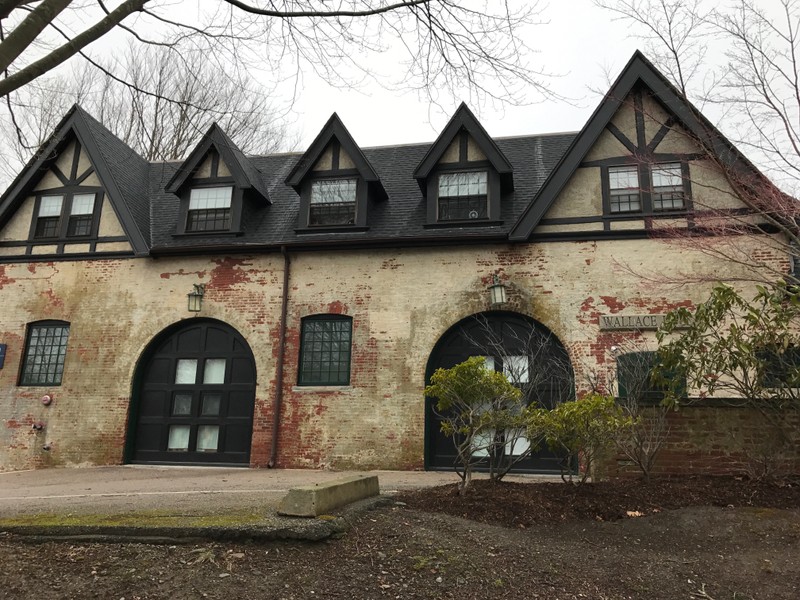 Street view of Slave Regina University's Wallace Hall, formerly known as Fairholme Carriage House and Stables. The arched entryways that were formerly used to store horse drawn carriages remain a distinguishing feature. 