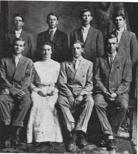 Black and white photo, students standing and sitting