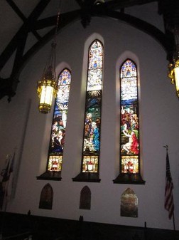 These stained glass windows depict the cathedral's history.