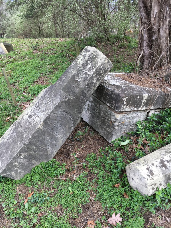 A close up of Colonel Milton Jameson Ferguson's headstone, now in a state of disrepair. Taken by Moriah Harman on March 31, 2017.
