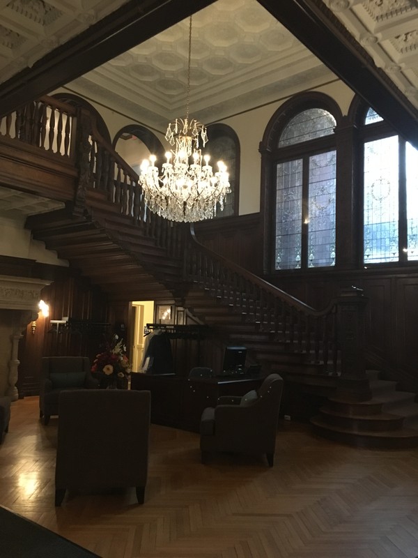 This is the foyer of Fairlawn Estate of which the elegant chandler hangs and the intricate woodwork greets each visitor.