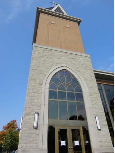 The steeple incorporating the belfry inspired by the original church's architecture. 