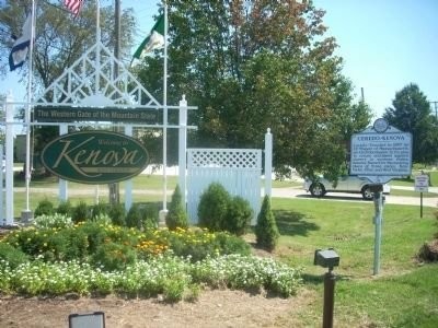 The marker stands next to U.S. Route at the western entrance to Kenova, facing the bridge to Catlettsburg, Kentucky. Image obtained from the Historical Marker Database.