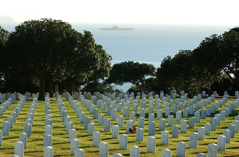 Fort Rosecrans National Cemetery with the Pacific Ocean and the USS Midway in the background