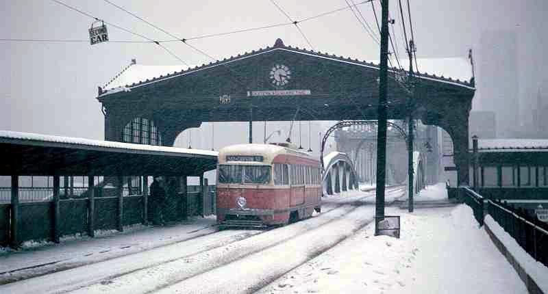 A trolley crosses under the trolley shelter which was removed in 1967.  
