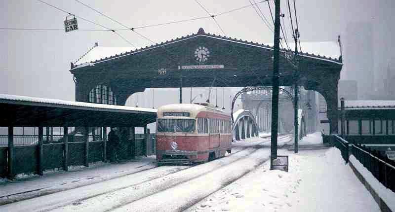 A trolley crosses under the trolley shelter which was removed in 1967.