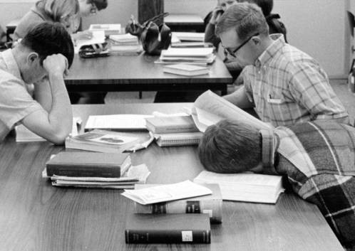 Students studying (and one napping) in the library at Boise College, ca. 1967.