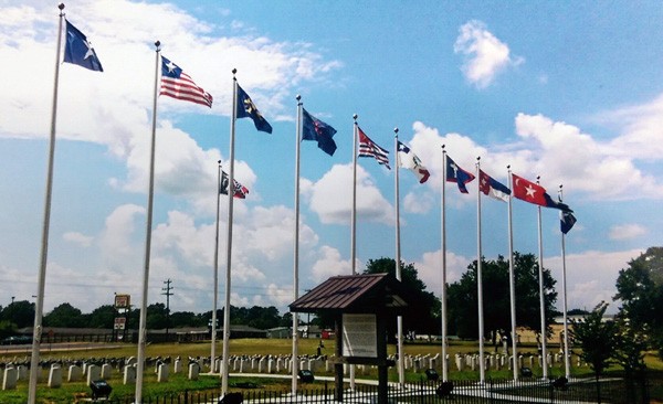 Cemetery with the flags flying in the wind. 